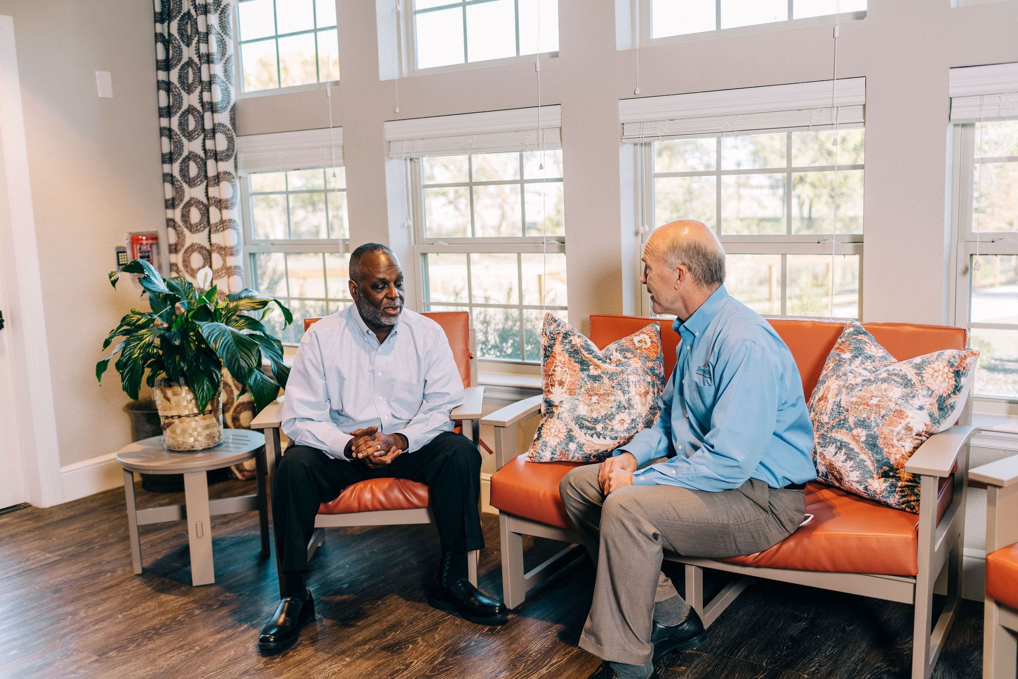 two men discussing senior care facilities philosophy