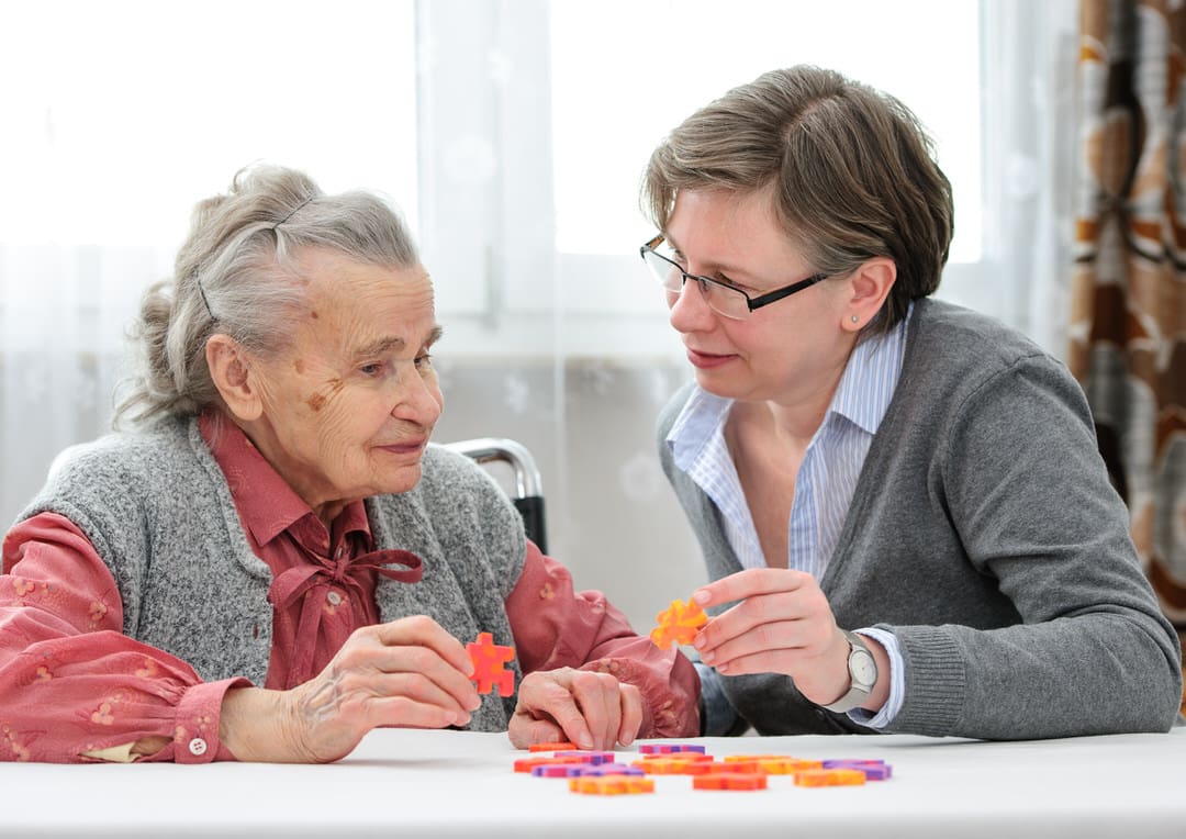 Senior woman with dementia with her elder care nurse